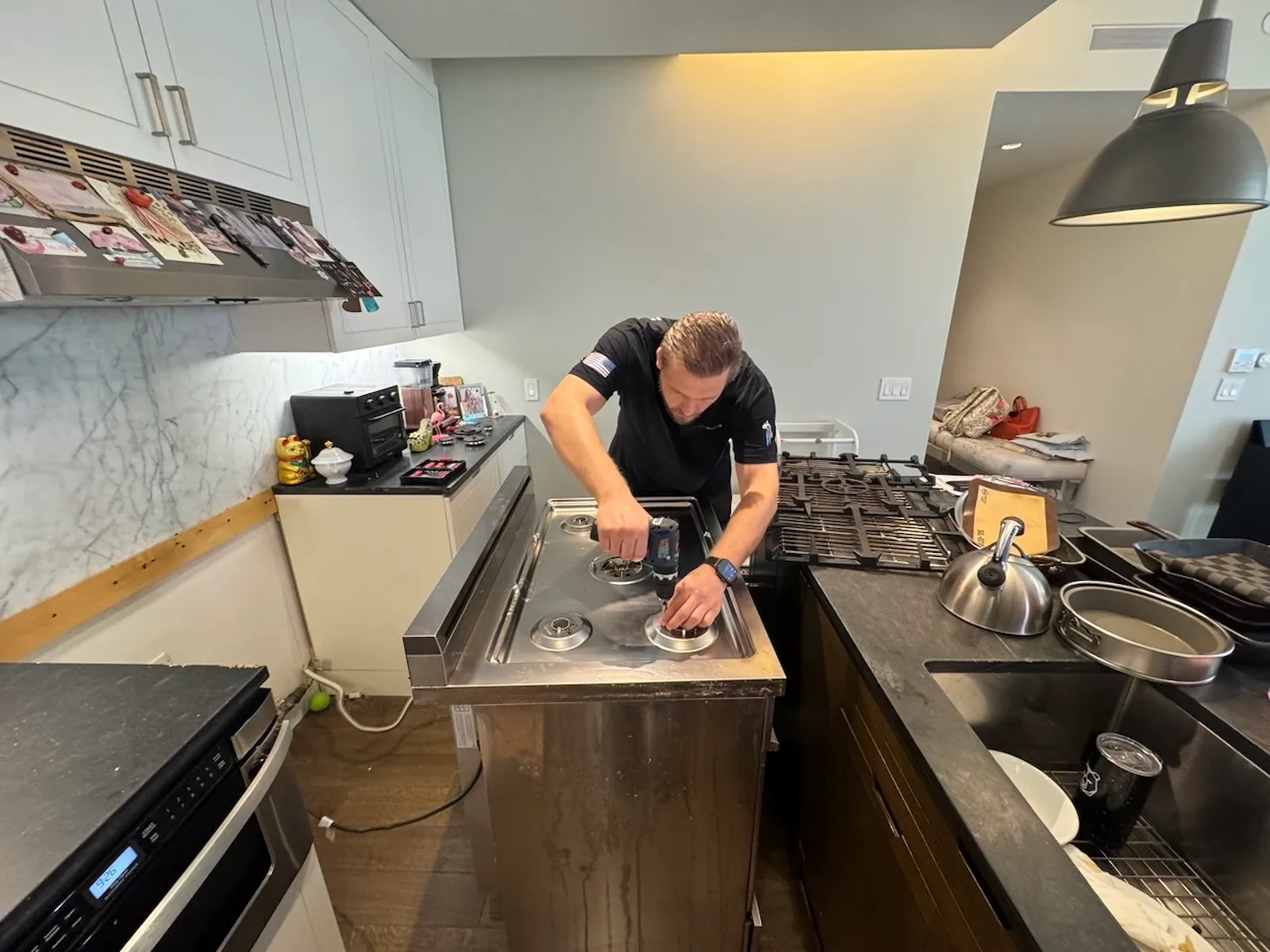 Elevate Repair technician repairing a cooktop in a NYC home
